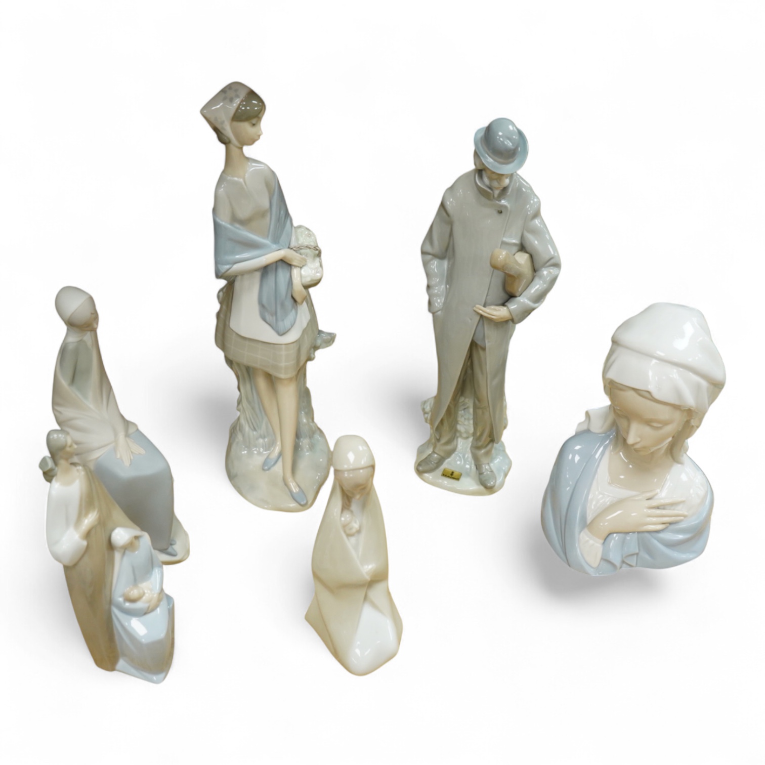A group of Lladro figures: Tramp with violin, Bust of Mary Magdalene, Holy family, Girl with child, Young Shepherds, Girl with basket, girl with jug
